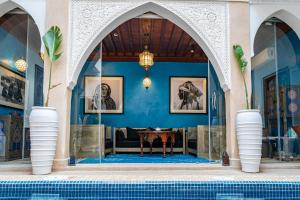 een villa met een zwembad en een woonkamer bij Riad Serendip in Marrakesh