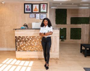 a woman is standing in front of a counter at Gillant Luxury Homes in Benin City +66 photos
