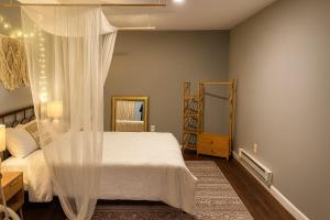 a bedroom with a white bed with a canopy at Wildlife with style in the mountains in Stanley