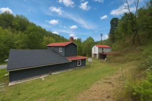 a house with a red roof on a green field at Wildlife with style in the mountains in Stanley +8 photos
