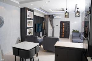 a salon with chairs and a table and a waiting room at Gillant Luxury Homes in Benin City