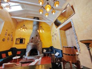 a living room with a large fireplace in a room at Ayni Boutique Hotel in Cusco