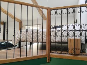 a bedroom with a bed with wrought iron fence at Gîte du Volcan des Causses in Saint-Jean-dʼAlcapiès +3 photos