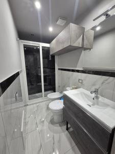 a bathroom with a toilet and a sink and a tub at Albicocche house Catania in Catania +27 photos