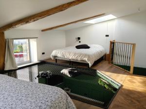 a bedroom with two beds and a window at Gîte du Volcan des Causses in Saint-Jean-dʼAlcapiès