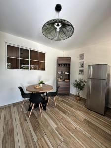 ein Esszimmer mit Tisch und Kühlschrank in der Unterkunft Apartamento C Fuertevali in San Salvador