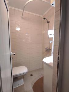 a bathroom with a toilet and a sink at 2 rooms apartment in the center in Nesebar