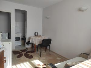 a kitchen with a table and chairs in a room at 2 rooms apartment in the center in Nesebar
