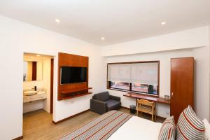 a hotel room with a bed and a television at Hotel Casa PARDO Boutique in Bogotá