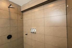 a bathroom with a shower with a tile wall at Hotel Casa PARDO Boutique in Bogotá +211 photos
