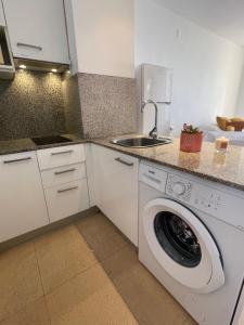 a kitchen with a washing machine and a sink at &luxe vista mar& in Calpe +9 photos