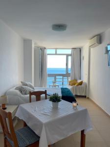 a living room with a table and a view of the ocean at &luxe vista mar& in Calpe