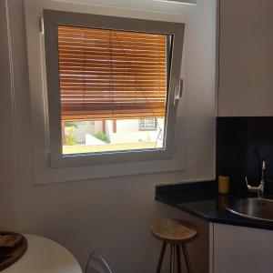 a window with a wooden blind in a kitchen at Apartament Sant Feliu de Guixols in Sant Feliu de Guixols +14 photos