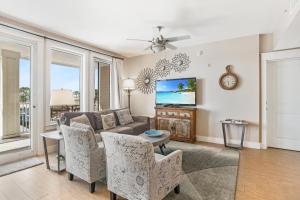 a living room with a couch and a tv at Observation Point North 456 in Destin