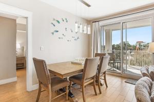 a dining room with a table and chairs at Observation Point North 456 in Destin
