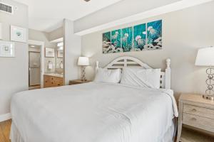 a white bedroom with a white bed and a bathroom at Observation Point North 456 in Destin +29 photos