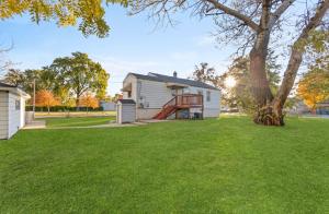 a white house with a tree in the yard at Serenity Home Free Parking & Wine in Burbank
