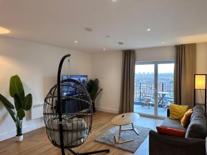 a living room with a couch and a chair at Cozy one Bedroom with Views In Birmingham City Center in Birmingham
