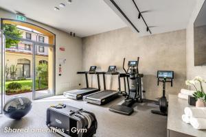 a fitness room with treadmills and elliptical machines at Agnesi Statue in Milan