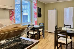 a kitchen and dining room with a table and chairs at Grand Hotell & Hostel Strömsund in Strömsund