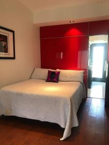 ein Schlafzimmer mit einem großen Bett mit rotem Kopfteil in der Unterkunft Lovely and Cozy Apartment in Colonia Cañón Doña Petra