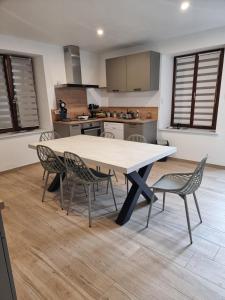 a kitchen with a table and chairs in a room at Chez Remi in Esmoulières
