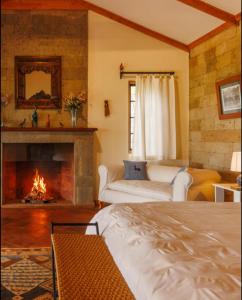 a living room with a fireplace and a bed at Laikipia farmstay Chui Cottage near Nanyuki - 2330 in Timau
