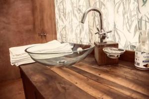 a bathroom with a bowl sink on a wooden counter at Laikipia farmstay Chui Cottage near Nanyuki - 2330 in Timau +28 photos