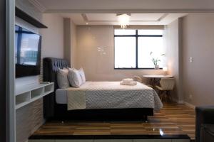 a small bedroom with a bed and a window at Studio-Apartment Center Pool Free Parking in Salvador +32 photos