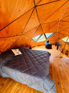 a bedroom with a bed in a tent at Domo Del Rio in Los Reartes