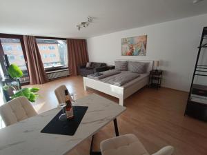 a living room with a couch and a table at Studio Apartment Staufenflair in Oberstaufen