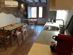 a kitchen with a sink and a table with a counter at Casa cova de Benifallet in Benifallet +27 photos