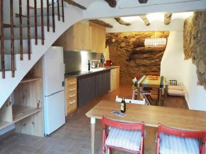 a kitchen with a table and a dining room at Casa cova de Benifallet in Benifallet