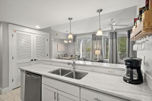 a kitchen with a sink and a counter top at Pilot House 413 in Destin