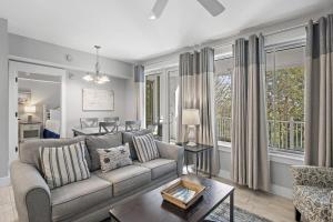 a living room with a couch and a table at Pilot House 413 in Destin +31 photos