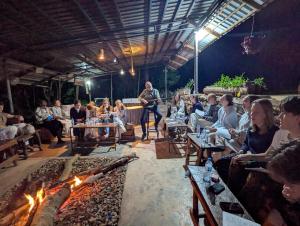a group of people sitting around a fire pit at LUSHOTO EXECUTIVE LODGE in Lushoto +251 photos