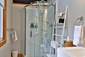 a bathroom with a glass shower and a sink at RoundTop Chalet - Hot Tub, Fire Pit & Mountain Views near Killington & Okemo in Plymouth +30 photos