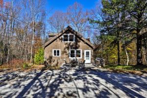 a house in the woods with a driveway at Classic Killington Ski Chalet for 8 with Gear Room, 2 Fireplaces, 5 Mins to Slopes in The Woods