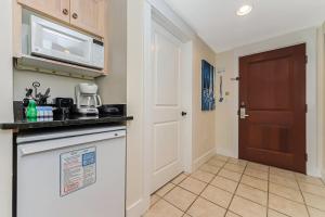 a kitchen with a stove and a microwave at Pilot House 507 in Destin