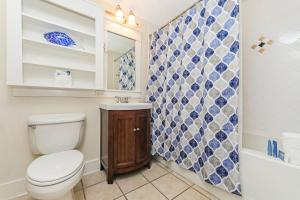 a bathroom with a toilet and a sink and a shower at Pilot House 507 in Destin +17 photos