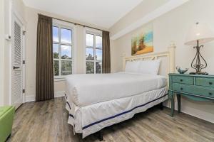 a bedroom with a large bed and a blue dresser at Pilot House 507 in Destin