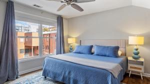 a bedroom with a bed and a large window at Downtown Condo - 2BR 2BA Walk to Everything in Raleigh