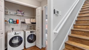 a laundry room with a washer and dryer at Downtown Condo - 2BR 2BA Walk to Everything in Raleigh