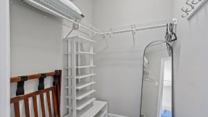 a white ladder in a room with a mirror at Downtown Condo - 2BR 2BA Walk to Everything in Raleigh