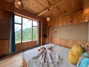 a bedroom with a bed in a wooden room at The Hidden Cabins in Jibhi