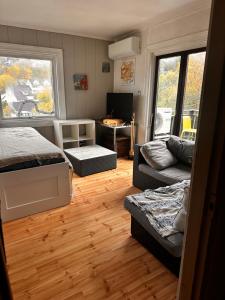 a bedroom with a bed and a couch and a desk at Oslo Nordstrand RESORT in Oslo