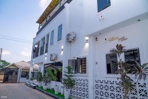 a white building with plants in front of it at Gillant Luxury Homes in Benin City