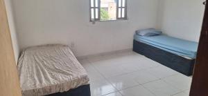 Voodi või voodid majutusasutuse Casa ds férias com piscina toas +38 fotot