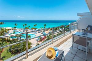 a balcony with a view of the beach and the ocean at Royal Islander Club Resort La Plage in Lowlands