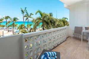 a balcony with a view of the beach at Royal Islander Club Resort La Plage in Lowlands